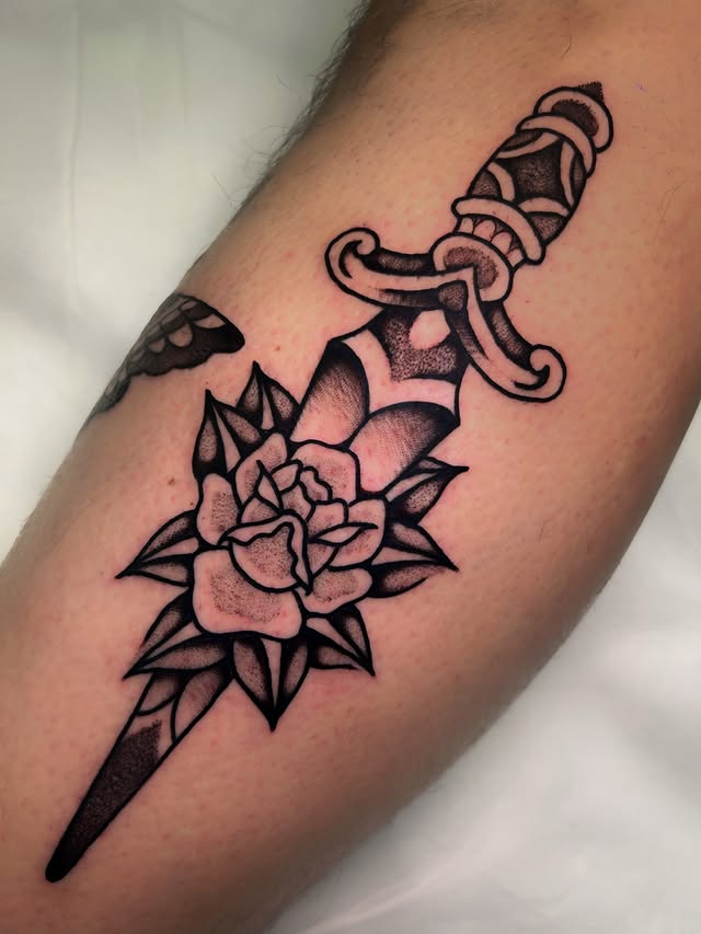 tatuaje daga con flor estilo blackwork tradicional